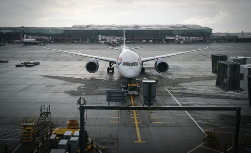 Airplane on runway against sky