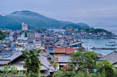 High angle view of townscape and bay against sky