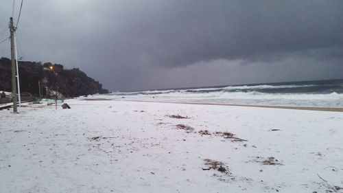 Scenic view of sea against cloudy sky