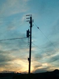 Low angle view of electricity pylon against sky