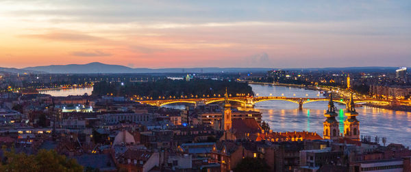 High angle view of city lit up at dusk