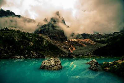Scenic view of sea and mountains against sky