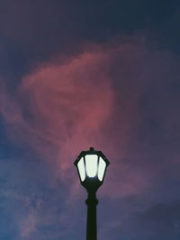 Low angle view of illuminated street light against sky