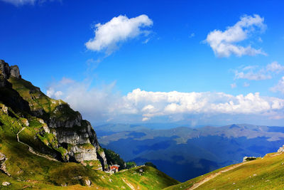 Scenic view of mountains against blue sky