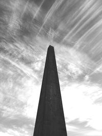 Low angle view of skyscraper against cloudy sky