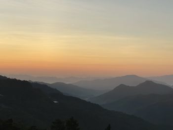 Scenic view of silhouette mountains against sky during sunset