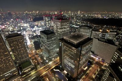 High angle view of city lit up at night