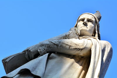 Low angle view of statue against blue sky