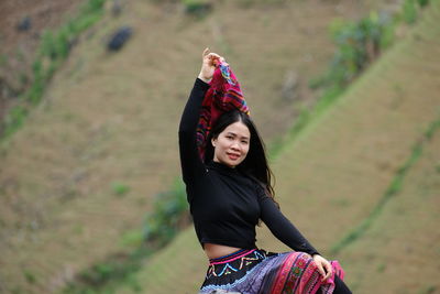 Portrait of young woman standing outdoors