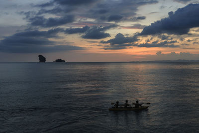 People kayaking at sunset near railay beach in krabi, thailand