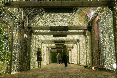 People walking in corridor of building