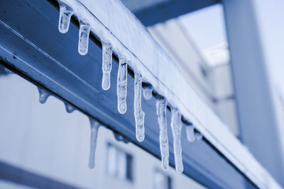 Low angle view of information sign on snow