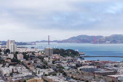 High angle view of city by sea against sky