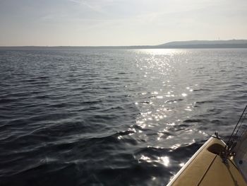 Close-up of boat sailing in sea against sky