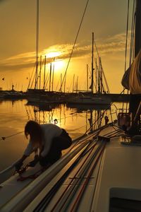 Boats in sea at sunset