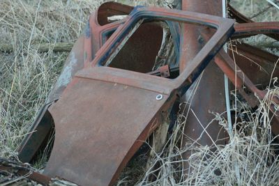 Close-up of abandoned wheel on field