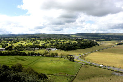 Scenic view of agricultural field against sky