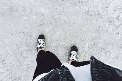 Low section of man standing on footpath