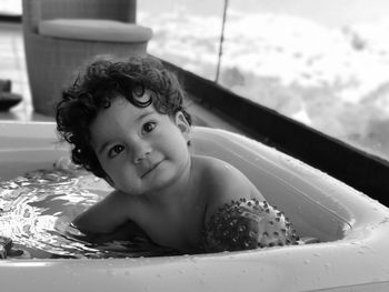 Smiling baby boy in bathtub