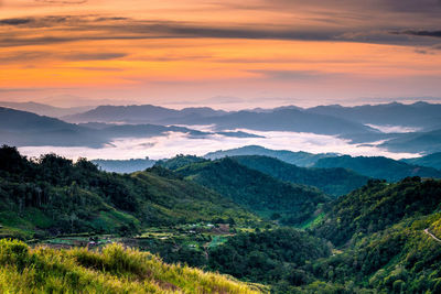 Scenic view of mountains against sky at sunset