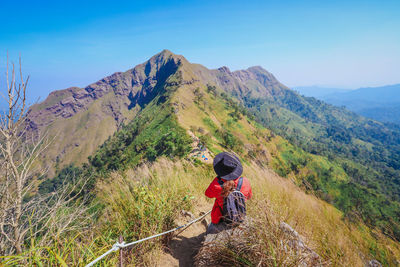 Man standing on mountain against sky