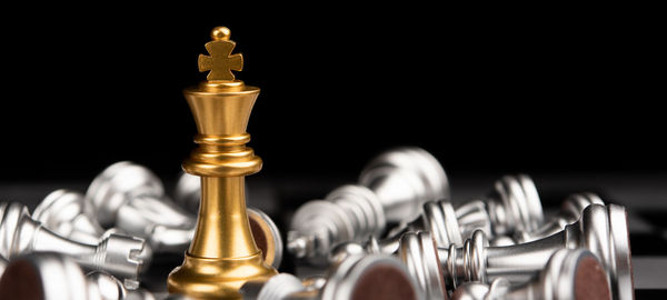 Close-up of chess pieces against black background