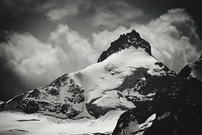 Scenic view of snow covered mountains against sky