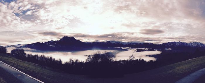 Scenic view of mountains against cloudy sky