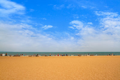 Scenic view of beach against blue sky