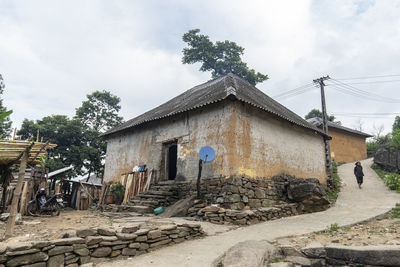 Exterior of house by building against sky