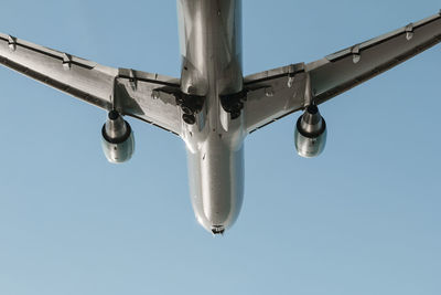 Low angle view of airplane against clear sky