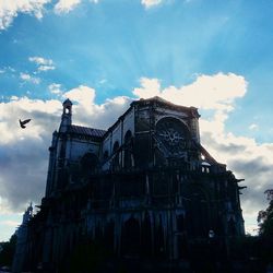 Low angle view of building against cloudy sky