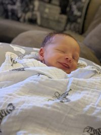 High angle view of boy sleeping on bed at home