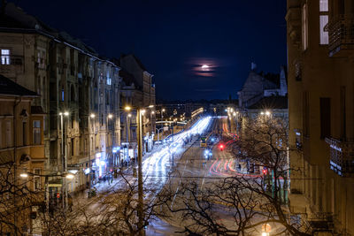 Illuminated street light in city at night during winter