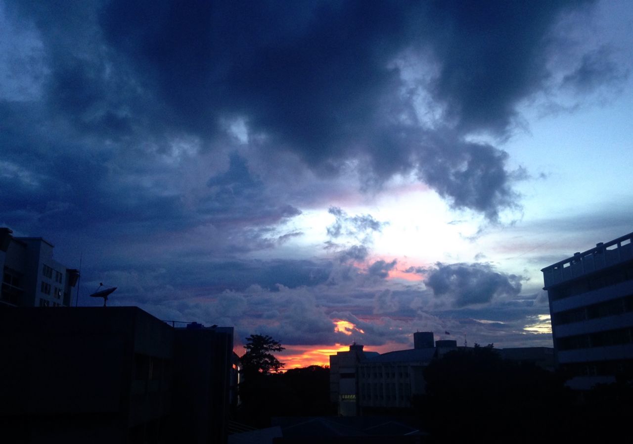 SILHOUETTE OF BUILDINGS AGAINST SKY AT SUNSET