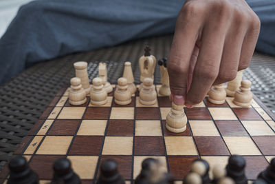 High angle view of man relaxing on chess board