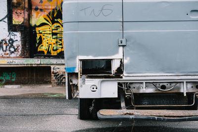 Close-up of van against graffiti on wall