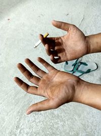 Close-up of hand holding cigarette