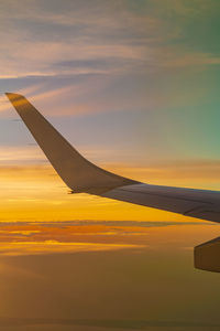 Airplane flying in sky during sunset