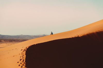 Scenic view of desert against sky during sunset