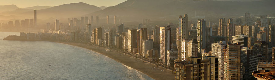 Panoramic view of buildings in city against sky