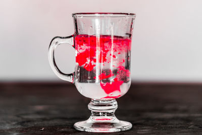 Close-up of red wine in glass on table