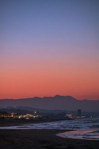 Scenic view of sea against romantic sky at sunset