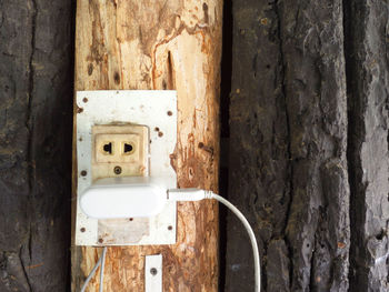 Close-up of old electric lamp on wall