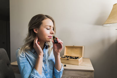 Portrait of a beautiful young woman sitting at home