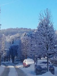 View of snow covered car against sky