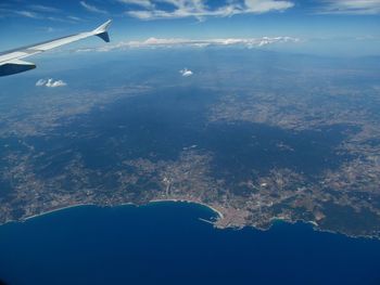 Aerial view of sea and mountains against sky