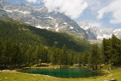 Scenic view of lake and mountains against sky