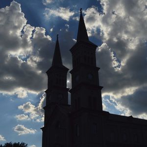 Low angle view of church against cloudy sky