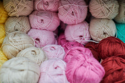 Close up of multicolored yarn balls in knitting shop center. a lot of color yarn for knitting